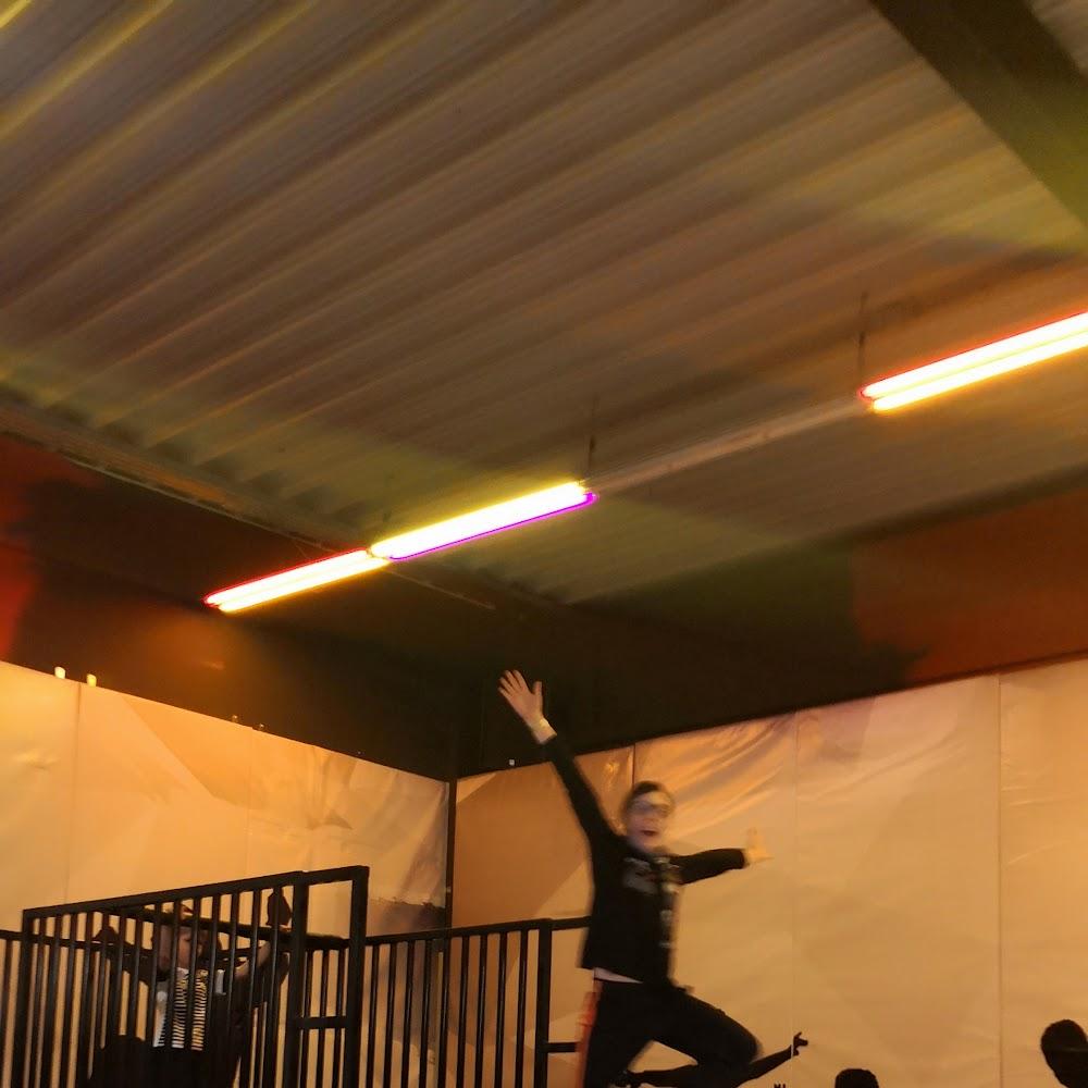 A person jumping in a trampoline park.